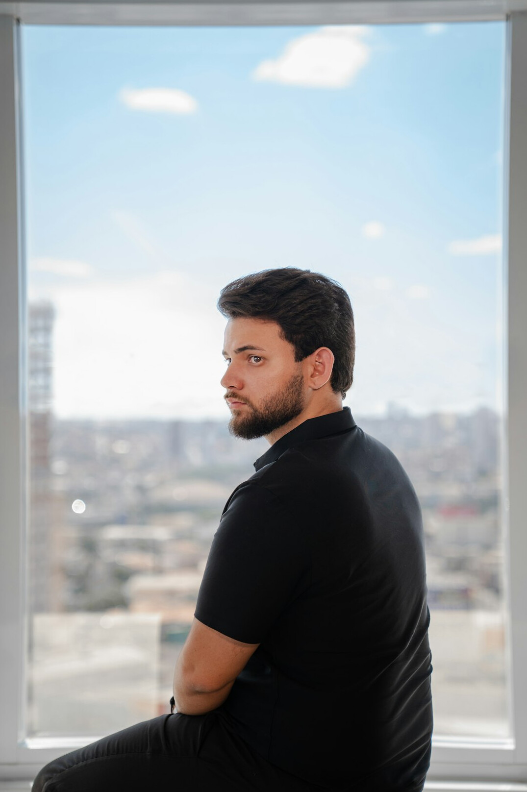 Studio portrait of a Croatian man with glasses in business casual attire